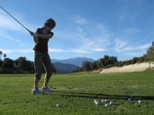 Sue swinging at the Chaparral Driving Range