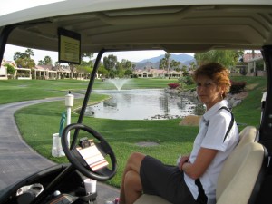 Sue in the golf cart at Oasis Golf Club