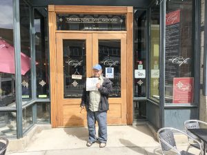 Dave with the NYT crossword in front of our breakfast cafe in Limon